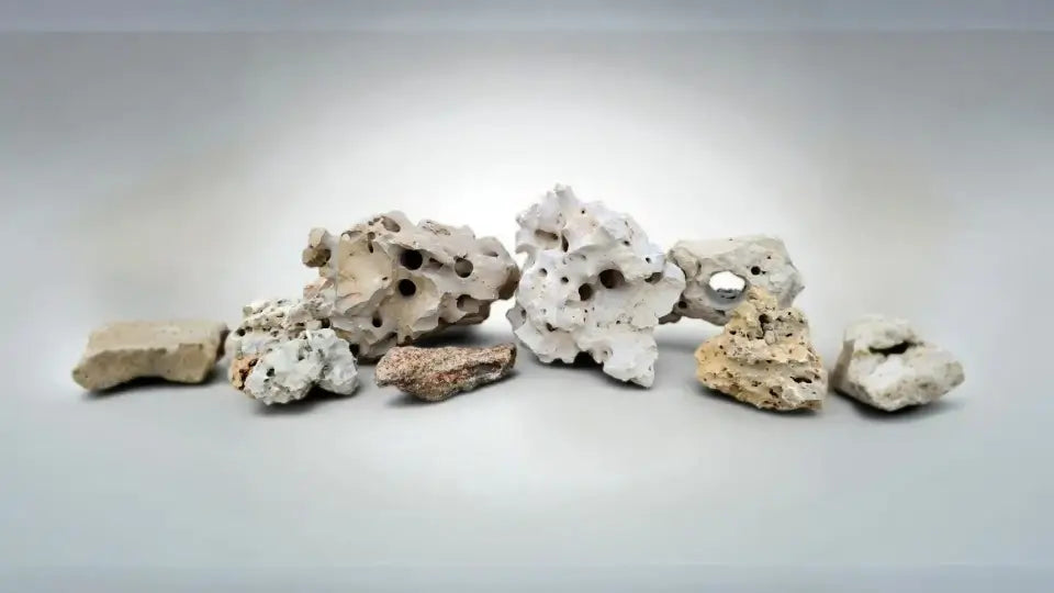Decorative aquarium rocks on a gray background